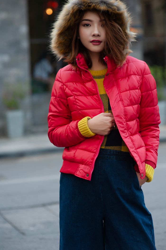 services-img Fashionable woman in a red puffer jacket with hood enjoying outdoor winter.